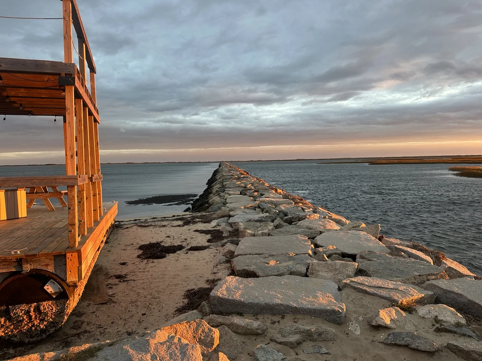 The Provincetown breakwater in warm evening light.