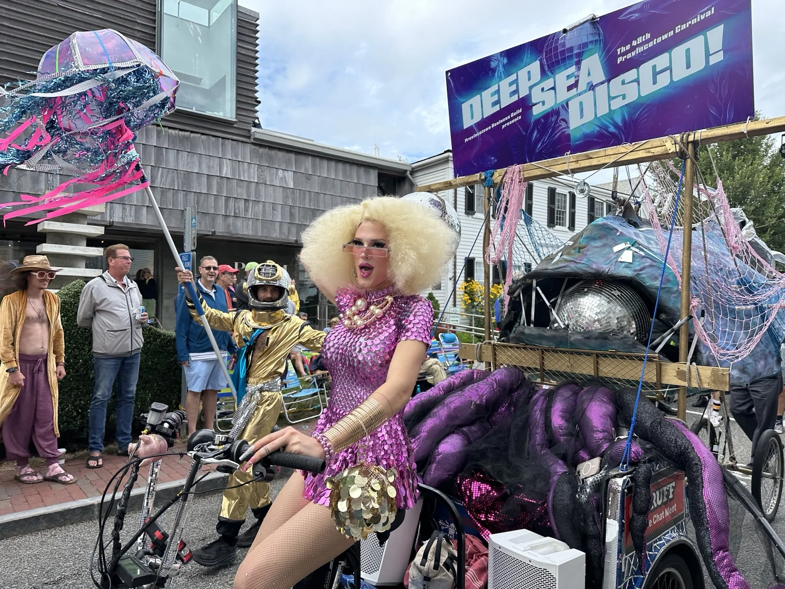 A decorated pedicab and costumed performer during Provincetown Carnival.
