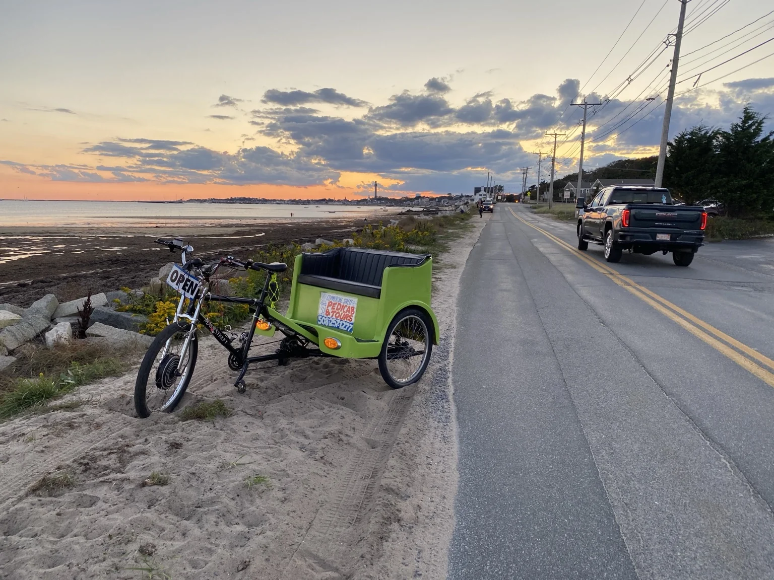 A pedicab by the water at sunset in Provincetown.
